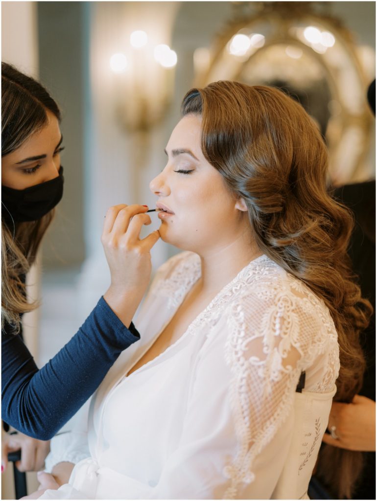 bride getting her makeup done at Dover Hall
