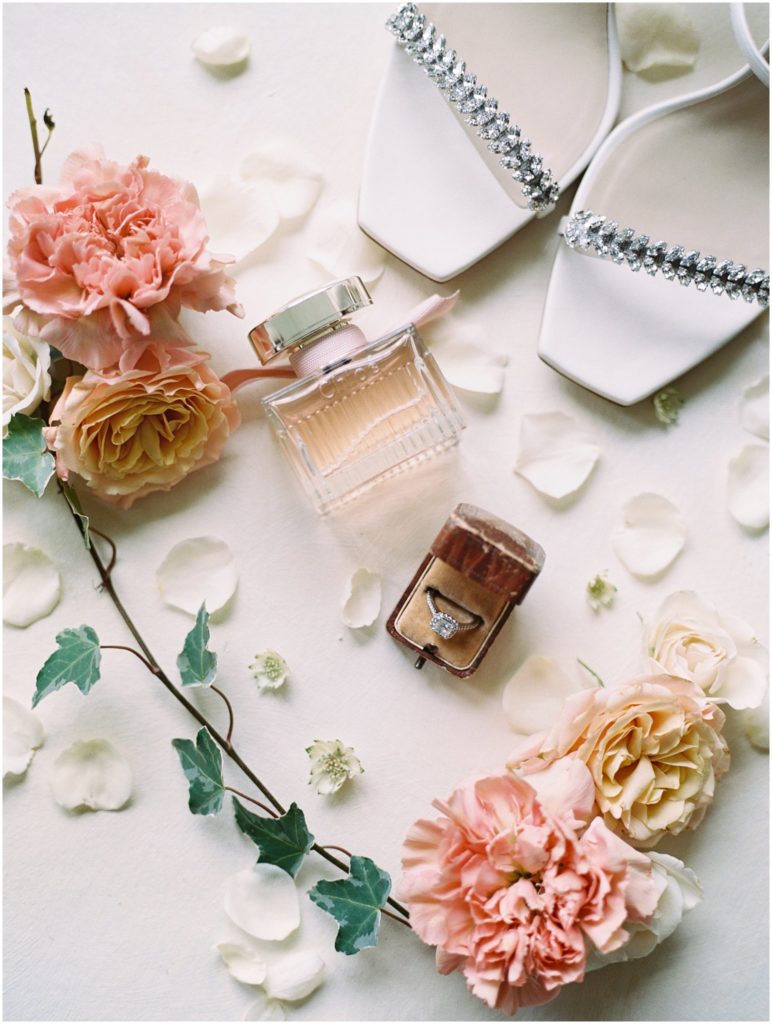 bride's perfume and an engagement ring flatlay